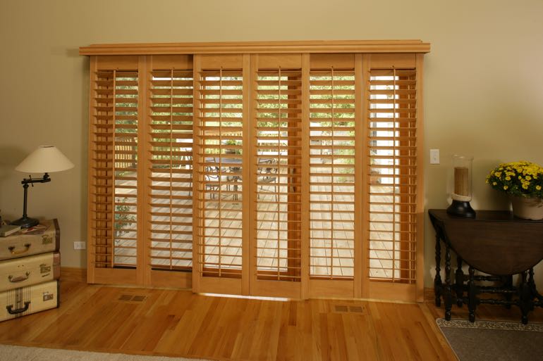 plantation shutters on sliding door going to full porch.